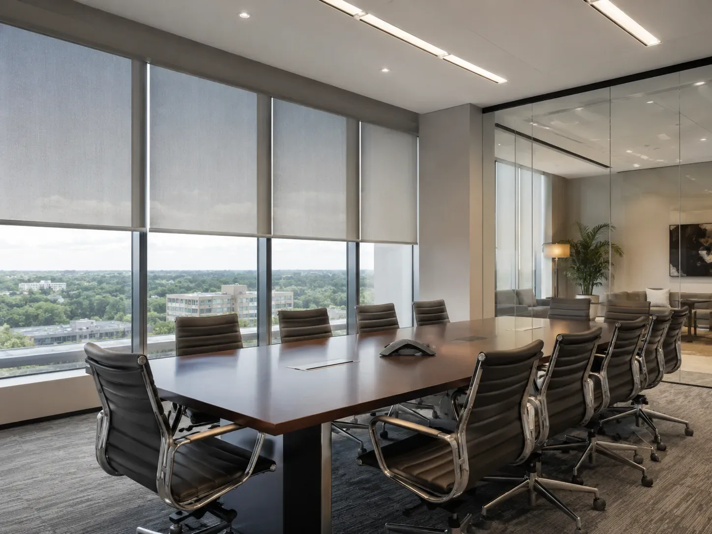 Open-plan office with uniform solar shades along a wall of windows